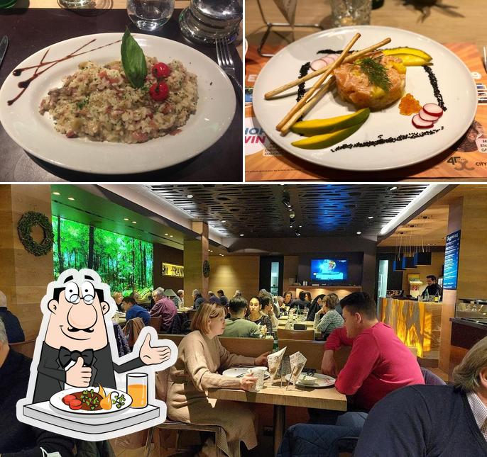 Salle du restaurant Am Besch — muraux forestiers, table dressée et ambiance chaleureuse